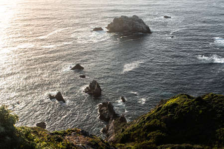 A sharp rocks in the waving ocean, California, USAの写真素材