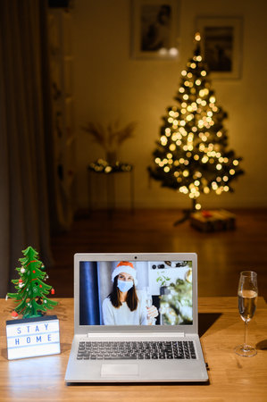 Video call with a woman in a medical maskの写真素材