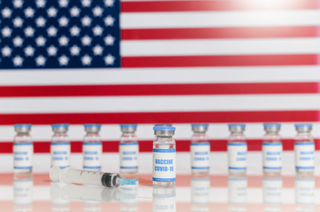 a lot of vials of vaccine on American flagの写真素材