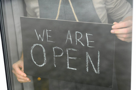 The onen sign board in barista hands