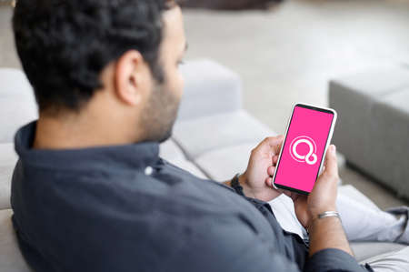 Kyiv, Ukraine - April 28, 2021: Smartphone in male hands with Google Fuchsia OS on the screen,...