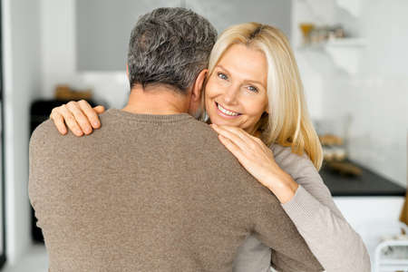 Love and support concept. Romantic middle-aged spouses, happy beautiful wife and grey-haired husband...