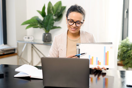 Businesswoman involved conference, tutor or business coach leading webinar. Middle aged female...