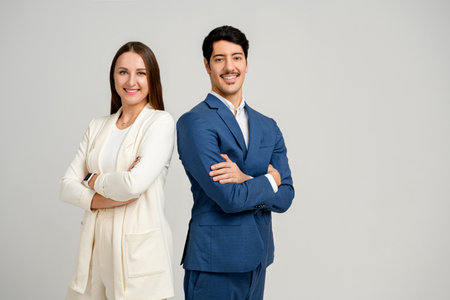 Businesswoman and businessman standing together back-to-back with arms crossed isolated, symbolizing strong corporate partnership and positive work culture, collaboration, equality, shared goalsの写真素材