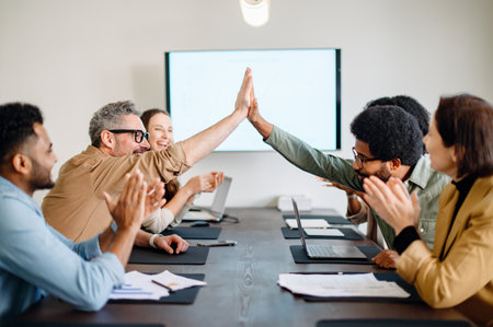 A team celebrates a shared success with high fives, encapsulating a moment of achievement and unity...