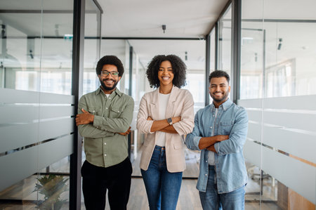 A diverse business team standing confidently in a modern office. A representation of teamwork, leadership, and corporate success in a professional setting.の写真素材