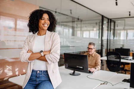 Confident businesswoman standing in a modern office, symbolizing leadership, career success, and corporate ambition. A professional environment promoting growth and innovation.の写真素材