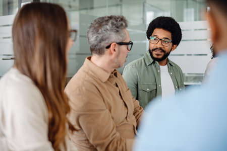 A focused discussion among business professionals in a sleek office setting. Innovation and strategy drive success, fostering teamwork and productivity in modern workplacesの写真素材