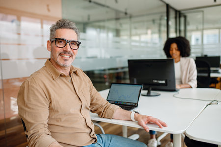 A modern office space with professionals working at their desks. A business environment promoting...