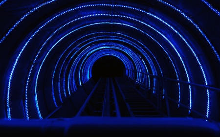 Dark tunnel with blue light lines in the form of an archの写真素材