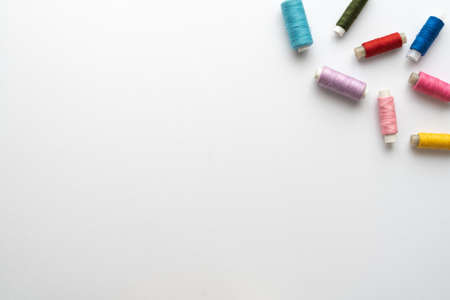 Flat lay composition with sewing thread on white background. Space for textの写真素材