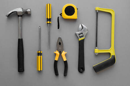 Flat lay composition with construction and home repair tools tools on gray background, space for textの写真素材