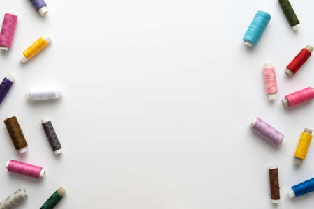 Flat lay composition with sewing thread on white background. Space for textの写真素材