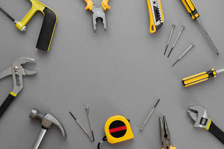 Flat lay composition with construction and home repair tools tools on gray background, space for textの写真素材