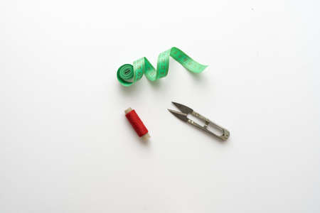 Flat lay composition with scissors and other sewing accessories on light background.の写真素材