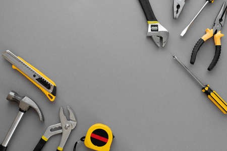 Flat lay composition with construction and home repair tools tools on gray background, space for textの写真素材