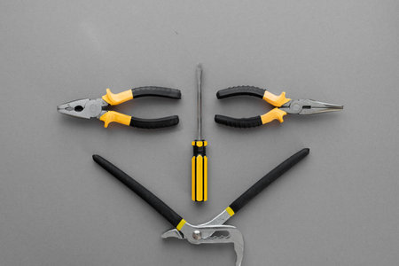 Flat lay composition with construction and home repair tools tools on gray background, space for...
