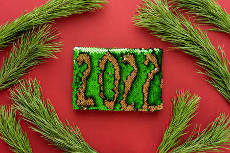 Christmas composition. Christmas decoration white tinsel on a red background. Flat lay, top view, space for textの写真素材