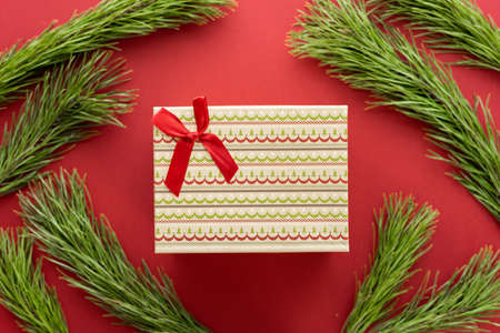 Christmas composition. Christmas decoration white tinsel on a red background. Flat lay, top view, space for textの写真素材