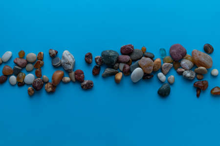 Flat lay composition sea pebbles on a blue background. space for textの写真素材