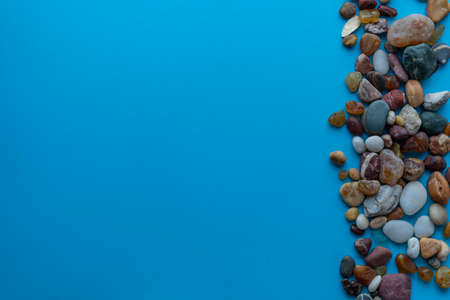 Flat lay composition sea pebbles on a blue background. space for textの写真素材