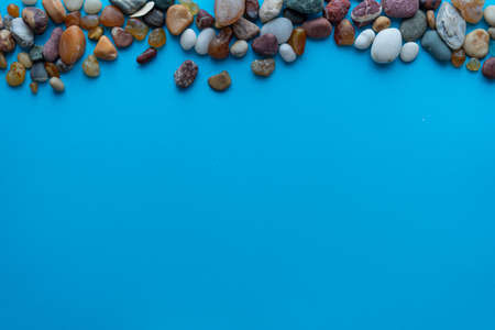 Flat lay composition sea pebbles on a blue background. space for textの写真素材