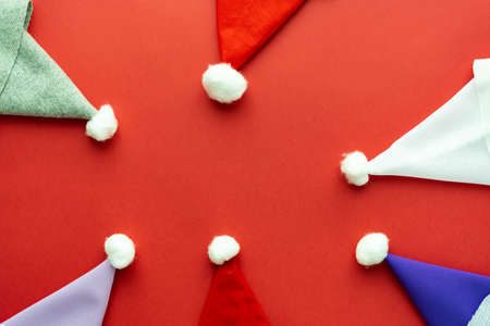 Christmas composition Santa Claus caps folded with a frame on a red backgroundの写真素材