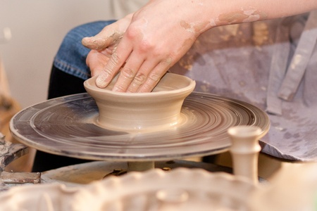 hands of a potter, creating an earthen jar on the circle のeditorial素材