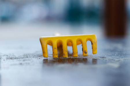 Children's plastic rake yellowの写真素材