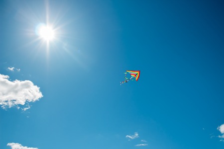 Kite flying against the background of cloudsの写真素材