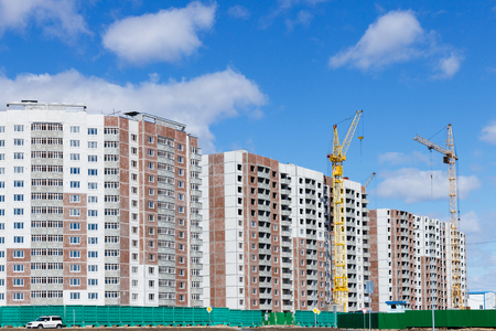 Building a multi-storey building with a tower craneの写真素材