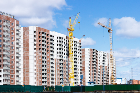 Building a multi-storey building with a tower craneの写真素材