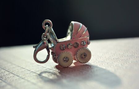 small baby carriage as pendantの写真素材