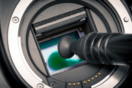 Image photo sensor being cleaned with a lens pen. DSLR APS-C.の写真素材