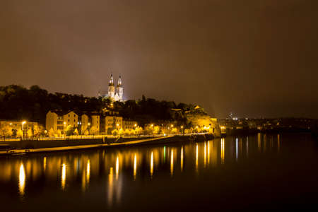 Prague Vysehrad castle at night with reflections in the riverの写真素材