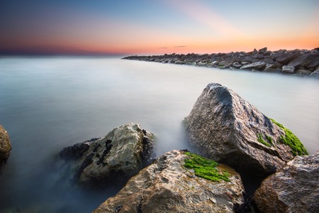 Nice long exposure seascape with rocks covered with moss.