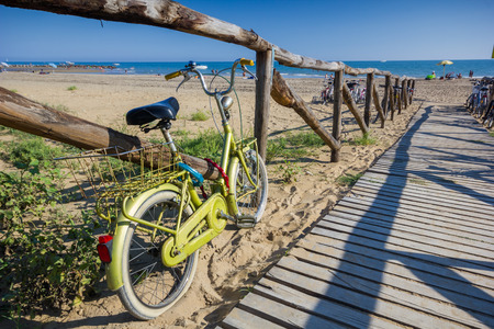 Nice retro vintage bicycle near beach on wooden road, sunny dayの写真素材