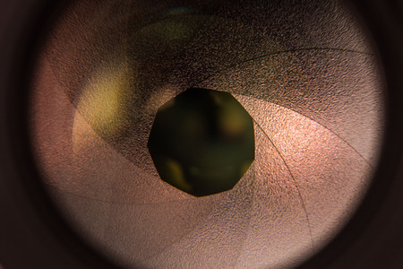 Camera lens aperture detail with colorful lens reflections - orange colorの写真素材
