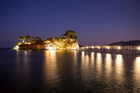 Fantastic night view of the Cameo Island. Slendid spring scene on the Port Sostis, Zakynthos island, Greece, Europe. Beauty of nature concept background.の写真素材