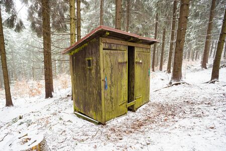 Wood cabin in the woods snow covered in winterの写真素材