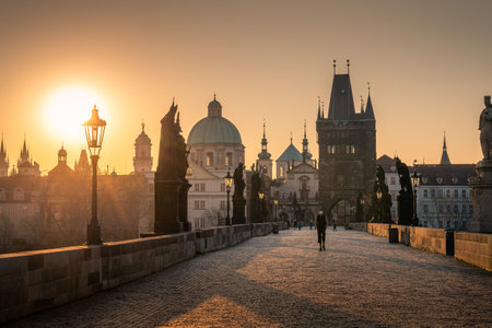 PRAGUE, CZECH REPUBLIC, APRIL 2020 - Man in respirator during covid lockdown, Charles bridge at sunrise, Old Town bridge tower, Prague UNESCO, Czech republic, Europe - Old townのeditorial素材
