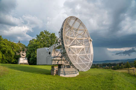Satellite dish in a summer landscape, radiotelescope for deep space research. Ondrejov observatory, Czech republic.の写真素材