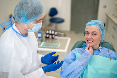 Dentist examining client in dental cabinetの写真素材