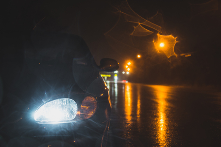 Yellow headlight and road in the dark while heavy raining.の写真素材