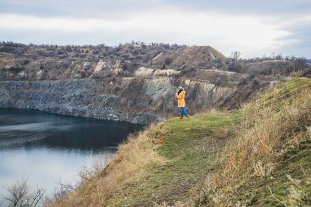 woman on a like in could autumn wather alone