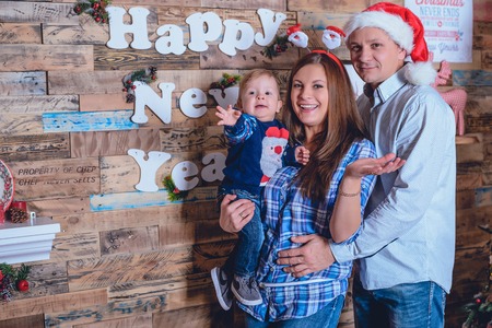 Cute yang family prepare for christmas with their little sonの写真素材