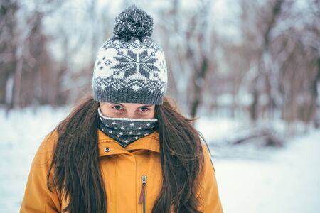 Beautiful winter portrait of young woman in the winter snowy sceneryの写真素材