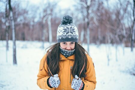 Beautiful winter portrait of young woman in the winter snowy sceneryの写真素材