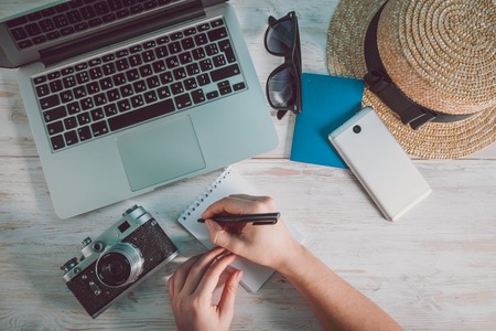 Hands of woman point to a blank sheet paper with cameraの写真素材