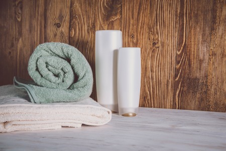 Stacked towels on wooden backgroundの写真素材